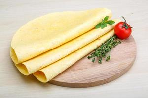 Tortilla on wooden board and wooden background photo