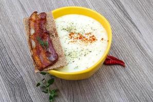 Cheese soup on wood photo