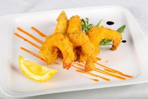 Crispy prawns on the plate and white background photo