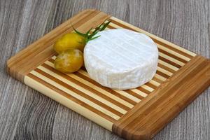 Brie cheese on wood photo