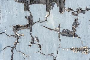 large dark cracks on a light-colored wall photo