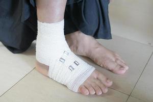 Woman with bandaged foot close up photo