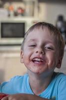 Cute boy eating watermelon at home. Real emotions without posing. photo