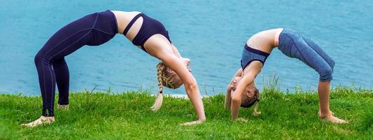 Mother and daughter doing exercise at the shore photo