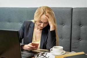 Woman looking upset while using smartphone. photo