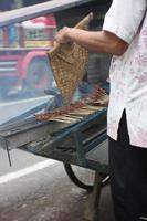 Magelang 05 10 2022. Sate sellers are burning in a manual and simple way photo