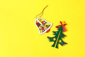 Christmas and New Year bell on yellow background photo