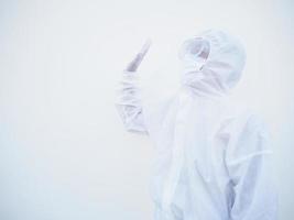 Asian male doctor or scientist in PPE suite uniform showing stop sign while looking ahead. coronavirus or COVID-19 concept isolated white background photo