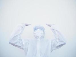 Positive young doctor or scientist in PPE suite uniform raising both hands to empty space above. coronavirus or COVID-19 concept isolated white background photo