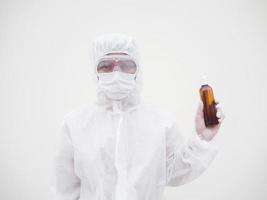 Portrait of doctor or scientist in PPE suite uniform holding plastic bottle with skin care product. COVID-19 concept isolated white background photo