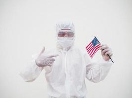 Portrait of doctor or scientist in PPE suite uniform holding national flag of United states of America. COVID-19 concept isolated white background photo