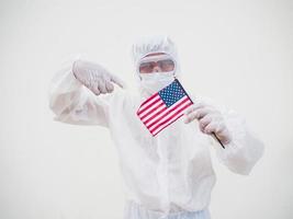 Portrait of doctor or scientist in PPE suite uniform holding national flag of United states of America. COVID-19 concept isolated white background photo