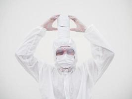 Asian male doctor or scientist in PPE suite uniform holding toilet paper. Lack of toilet paper in the quarantine of coronavirus. COVID-19 concept isolated white background photo