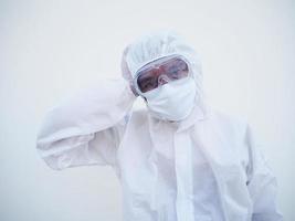 Asian male doctor or scientist in PPE suite uniform showing that feeling strees and headache. coronavirus or COVID-19 concept isolated white background photo