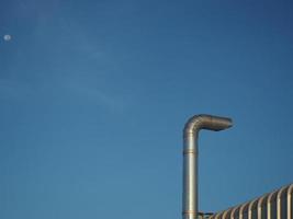 Stainless steel chimney on a blue sky background. photo