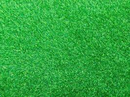 Closeup view of green grass soccer field background. Wallpaper for work and design. photo