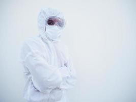 Portrait of confident asian male doctor or scientist in PPE suite uniform while folding his hands in the white background. Copy space for text or design. coronavirus or COVID-19 concept. photo