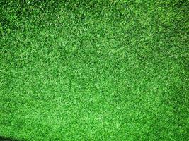 Closeup view of green grass soccer field background. Wallpaper for work and design. photo