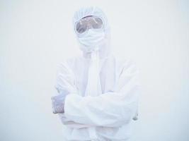 Portrait of confident asian male doctor or scientist in PPE suite uniform while folding his hands in the white background. coronavirus or COVID-19 concept. photo