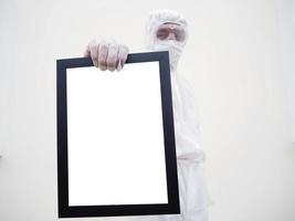 Asian doctor or scientist in PPE suite uniform. holding white screen square black frames for your design. coronavirus or COVID-19 concept isolated white background photo