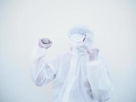 Successful emotional asian doctor or scientist in PPE suite uniform while looking ahead. clenches fists with pleasure, happiness, celebrates his victory, has great triumph.  isolated white background photo