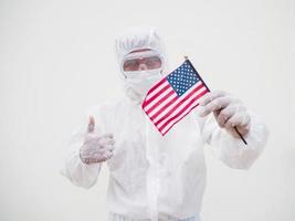 Portrait of doctor or scientist in PPE suite uniform holding national flag of United states of America. COVID-19 concept isolated white background photo