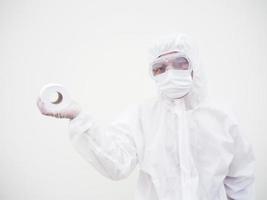 Asian male doctor or scientist in PPE suite uniform holding toilet paper. Lack of toilet paper in the quarantine of coronavirus. COVID-19 concept isolated white background photo