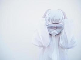 Asian male doctor or scientist in PPE suite uniform showing that feeling strees and headache. coronavirus or COVID-19 concept isolated white background photo