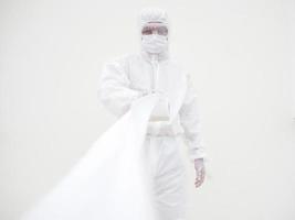 Asian male doctor or scientist in PPE suite uniform holding toilet paper. Lack of toilet paper in the quarantine of coronavirus. COVID-19 concept isolated white background photo