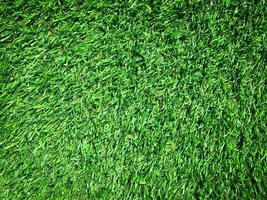 Artificial green lawn backyard for background. Texture for design photo