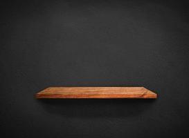 Light wood shelves on black wall texture in loft Style  background with clipping path. Design for wallpaper photo