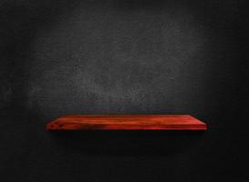 Blank of old wooden shelf on dark wall texture background with clipping path for design photo