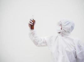 Portrait of doctor or scientist in PPE suite uniform holding plastic bottle with skin care product. COVID-19 concept isolated white background photo