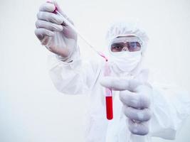 Asian doctor or scientist in PPE suite uniform. Personal protective equipment suit dropping a blood into blood test tube. coronavirus or COVID-19 concept isolated white background photo