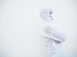 Side view portrait of confident asian male doctor or scientist in PPE suite uniform while folding his hands in the white background. coronavirus or COVID-19 concept. photo