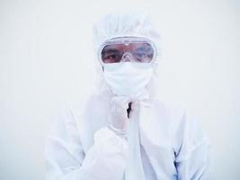 Portrait of confident asian male doctor or scientist in PPE suite uniform empty space deep thinking creative person hand on chin with looking ahead on white background. COVID-19 concept. photo