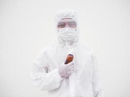 Portrait of doctor or scientist in PPE suite uniform holding plastic bottle with skin care product. COVID-19 concept isolated white background photo