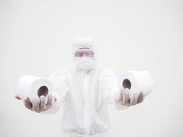 Asian male doctor or scientist in PPE suite uniform holding toilet paper. Lack of toilet paper in the quarantine of coronavirus. COVID-19 concept isolated white background photo