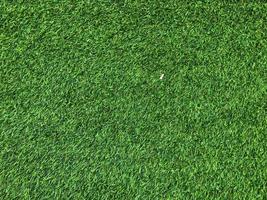 Modern green lawn texture background. Wallpaper for work and design. photo