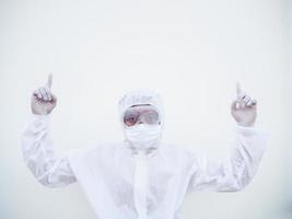 Doctor or scientist in PPE suite uniform showing both hands poiting up to empty space above. coronavirus or COVID-19 concept isolated white background photo