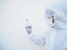 Asian doctor or scientist in PPE suite uniform holding medical injection syringe. coronavirus or COVID-19 concept isolated white background photo