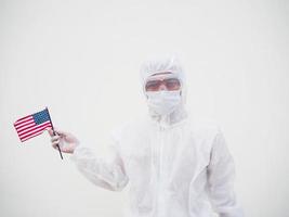 Portrait of doctor or scientist in PPE suite uniform holding national flag of United states of America. COVID-19 concept isolated white background photo