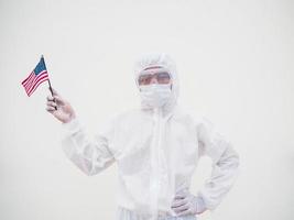 Portrait of doctor or scientist in PPE suite uniform holding national flag of United states of America. COVID-19 concept isolated white background photo