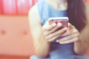 female hand holding pointing finger on screen mobile smartphone touching screen and using app. information content,  reading text message on cell telephone during in urban. photo