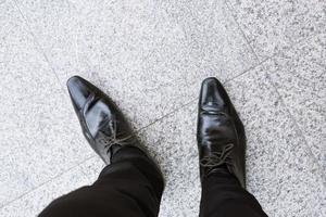 people black shoes jeans standing on the concrete floor with a copy space. top view photo