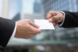 business man in hand hold show business cards blank white card mock up filing give to connect business contacts. Business branding concept. photo