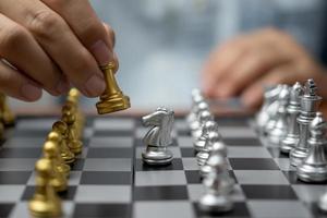 Businessman play on chess board game for ideas and competition and strategy success, business competition planing teamwork management or leadership concept. photo