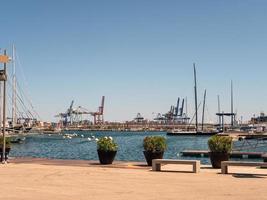 scenic photo of the port with yachts and ships moored in the background