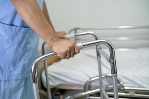 Asian lady woman patient walk with walker at nursing hospital ward, healthy strong medical concept photo