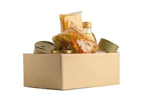 Foodstuff for donation, storage and delivery. Various food, pasta, cooking oil and canned food in cardboard box. photo